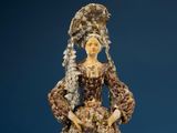 statue of a woman in a dress made of shells and shells