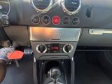 a dashboard of a car with a steering wheel and a dash button