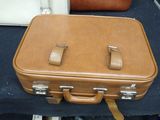 two pieces of luggage sitting on a table next to each other