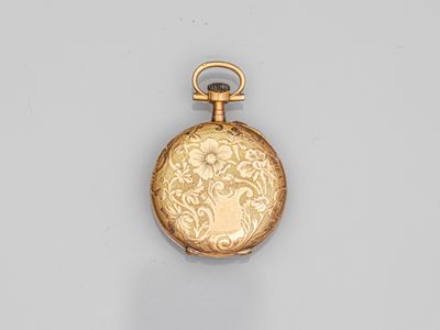 an image of a gold pocket watch with a floral design on it
