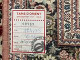 a close up of an oriental rug with a tag on it