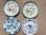 three plates with different designs on them sitting on a table