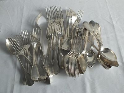 a lot of forks and spoons sitting on a table