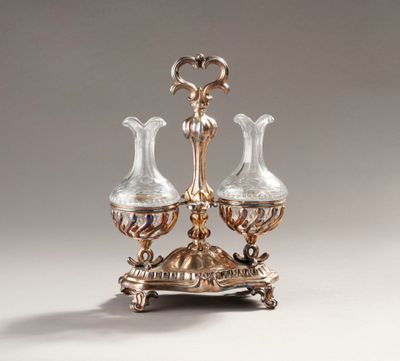 an antique silver plated three - light candle holder with two glass vases
