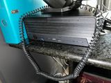 a blue phone sitting on top of a counter next to a blue box