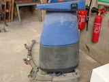 a blue machine that is sitting in a garage