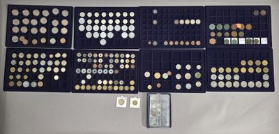 many different types of coins in a display case