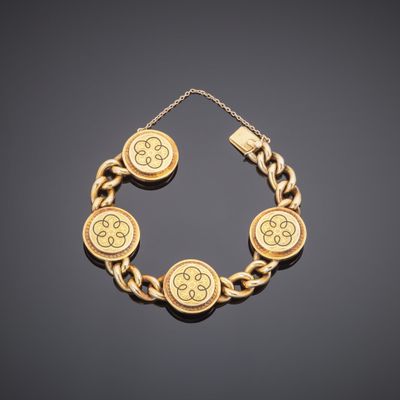 a gold bracelet with four medallions on a chain