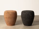 a pair of black and brown stools sitting on top of a cement floor