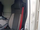 two seats in the back of a van with red trims