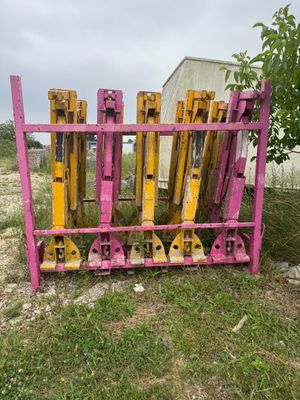 une clôture rose et jaune au milieu d'un champ recouvert d'herbe