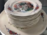 a stack of plates and silverware sitting on a table