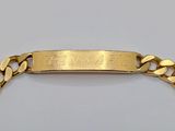 a close up of a gold bracelet with a name engraved on it
