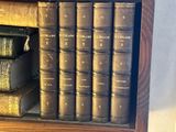 many old books on a shelf in a book case