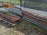 a pile of wood sitting on the ground next to a fence