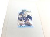an open book with a picture of a mountain on it