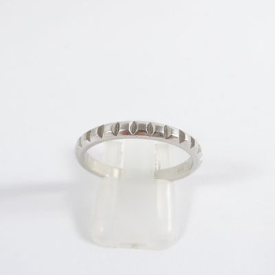 a close up of a silver ring on a white surface