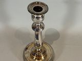 a silver candle that is sitting on a table