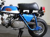 a blue and black motorcycle parked in a garage