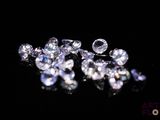 some very pretty diamonds on a black surface with a black background