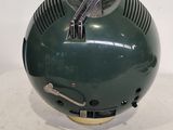 a green helmet with a pair of scissors in it