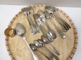 a lot of silver spoons and spoons on a tray