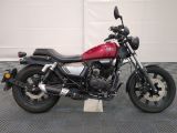 a red motorcycle that is parked in a garage