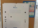an image of a refrigerator in a room with a cork board