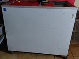 a small kitchen with a red wall and a white cabinet