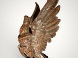 an image of a statue of a bird on a wooden base