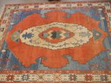 an orange and blue area rug with a design on it