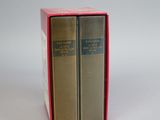 two books in a red box on a white surface