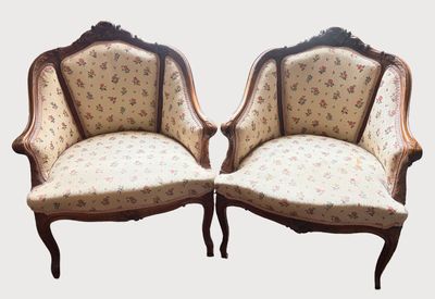 pair of antique french style chairs with floral upholstered upholstered cushions