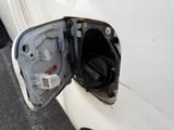 a white car with a gas pump attached to it