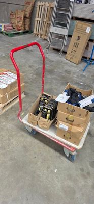 un chariot chargé de cartons et un diable sur lequel sont posés des outils