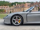 a silver sports car parked in front of a building