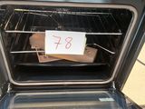 a note taped to the door of an oven