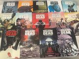 the walking dead comic books are lined up on a bed
