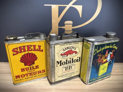 three vintage shell oil cans sitting on top of a wooden table