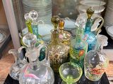 many glass vases and dishes on the counter