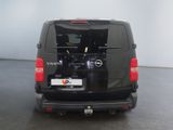 a black van parked in a room with a white wall