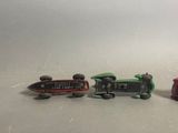 three toy trains sitting next to each other on a table