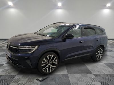 a dark blue suv parked on a checkered floor in a garage