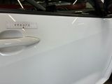 a close up of a car door handle with a sticker on it