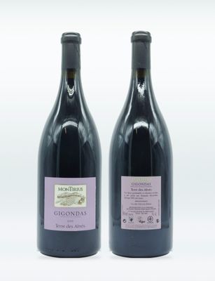 two bottles of wine sitting next to each other on a white surface