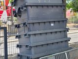 a pile of plastic containers sitting on the ground next to a fence