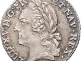 a silver coin with an image of a woman in profile