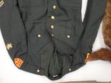 uniform worn by a soldier with a dog laying on the ground