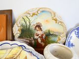 a plate with a picture of a woman on it next to other plates