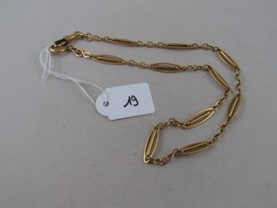 a close up of a gold chain with a tag on it